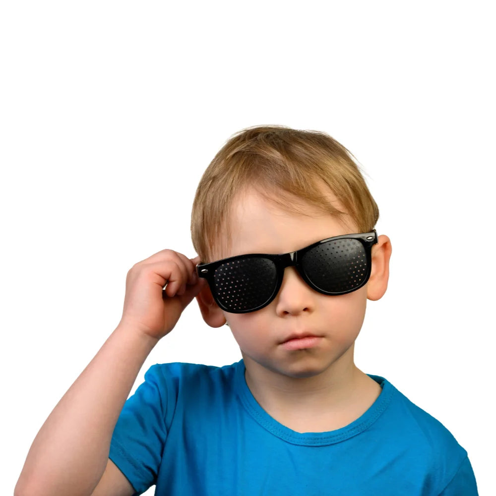 A kid wearing HopeLens pinhole glasses to train his eyes muscles.